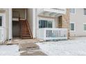 Exterior view showcasing the building entrance, stairs, and a small outdoor space at 14141 E Jewell Ave # 101, Aurora, CO 80012
