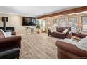 Spacious living room featuring hardwood floors, a fireplace, and large windows for ample natural light at 28268 Shadow Mountain Dr, Conifer, CO 80433