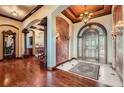 Elegant foyer with hardwood floors, arched doorways, and decorative ceiling creating a grand entrance at 4725 Palmer Ridge Dr, Parker, CO 80134