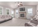 Inviting living room with plush sofas and a stone fireplace, creating a warm and welcoming atmosphere at 525 Remington Dr, Hudson, CO 80642