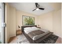 Comfortable bedroom with a ceiling fan, neutral tones, and ample natural light at 17093 E Tennessee Dr # 211, Aurora, CO 80017