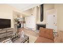 Bright living area showcasing a fireplace, and seamless access to the kitchen at 17093 E Tennessee Dr # 211, Aurora, CO 80017