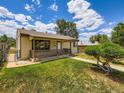 Quaint single-story house with a screened-in porch and well-kept front lawn at 235 S Stuart St, Denver, CO 80219