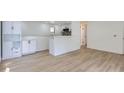 Open floor plan living room, kitchen in the background, luxury vinyl flooring, fresh paint throughout at 235 S Stuart St, Denver, CO 80219