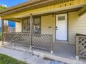 Close-up of a home's covered front porch with lattice railings and the house number displayed at 235 S Stuart St, Denver, CO 80219