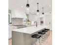 Modern kitchen boasts a large center island with seating and professional grade appliances at 4930 E Ellsworth Ave, Denver, CO 80246