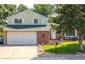 Lovely two-story home with a brick and siding exterior, a two-car garage, and a well-kept lawn at 2254 S Eagle St, Aurora, CO 80014