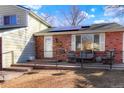 Inviting front porch featuring a cozy seating area, with solar panels, and a welcoming entrance at 2254 S Eagle St, Aurora, CO 80014