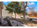 Outdoor seating area with comfortable chairs and a view of the quiet neighborhood street at 2254 S Eagle St, Aurora, CO 80014