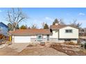 Charming home featuring a well-maintained front yard, attached garage, and neutral exterior paint at 13131 Mercury Dr, Lone Tree, CO 80124