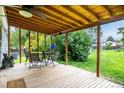 Outdoor deck space featuring a dining table with chairs, offering a relaxing area overlooking the backyard at 11886 Birch Dr, Thornton, CO 80233