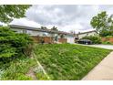 Attractive single-story home with a well-maintained lawn, brick accents, and an attached garage at 11886 Birch Dr, Thornton, CO 80233