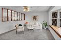 Bright living room with a plush carpet, a comfortable sofa, and a large window at 11157 W Marlowe Ave, Littleton, CO 80127
