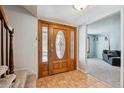Grand entryway featuring a decorative wooden front door, tile flooring, and staircase at 4693 Chatham St, Boulder, CO 80301
