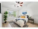 Cozy bedroom featuring a ceiling fan, large window, and ample natural light at 8200 E 8Th Ave # 5-204, Denver, CO 80230