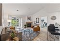 Bright living room with fireplace, balcony access, and views into the primary bedroom at 8200 E 8Th Ave # 5-204, Denver, CO 80230