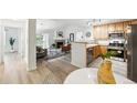 Open-concept living space with fireplace, bright kitchen, and dining area at 8200 E 8Th Ave # 5-204, Denver, CO 80230