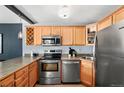 Well-equipped kitchen with stainless steel appliances, light wood cabinetry, and ample counter space at 909 N Logan St # 8F, Denver, CO 80203