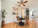 Inviting dining area with hardwood floors, neutral wall colors, and a decorative ceiling fan at 2301 E Fremont Ave # W03, Centennial, CO 80122