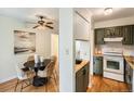 Open layout showcasing kitchen and dining areas, with sage cabinets and modern appliances at 2301 E Fremont Ave # W03, Centennial, CO 80122