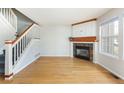 Bright living room boasts hardwood floors, a decorative fireplace, and staircase at 3098 W 107Th Pl # C, Westminster, CO 80031