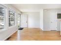 Sunny living room with hardwood floors and neutral walls. Door shown in background at 3098 W 107Th Pl # C, Westminster, CO 80031