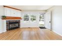 Cozy living room with hardwood floors, built-in cabinet, and inviting fireplace at 3098 W 107Th Pl # C, Westminster, CO 80031