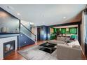 Open living room showcasing a fireplace and kitchen views at 3438 Cade Ct, Castle Rock, CO 80104