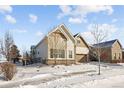 Beige two-story house with brown accents and a two-car garage at 7394 S Scottsburg Way, Aurora, CO 80016