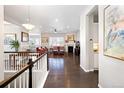 Spacious living room with hardwood floors, fireplace, and red couches at 7394 S Scottsburg Way, Aurora, CO 80016