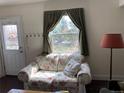 Cozy living room with floral sofa and a large window providing ample natural light at 75 Pierce St, Lakewood, CO 80226