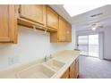 Bright kitchen featuring a double basin sink with laminate countertops at 1301 S Cathay Ct # 104, Aurora, CO 80017