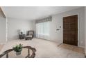 Inviting living room with neutral carpet and bright natural light at 7644 Wyandot St, Denver, CO 80221