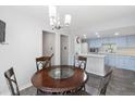 Bright dining area features an elegant chandelier and opens to the kitchen at 7172 S Vine Cir, Centennial, CO 80122