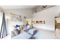 Inviting living room boasting tall ceilings and seamless flow to the kitchen area at 3600 S Pierce St # 5-202, Denver, CO 80235