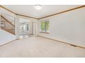 Bright living room with neutral carpet, white walls, wood trim, and natural light from large windows at 9346 Lark Sparrow Dr, Highlands Ranch, CO 80126