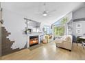 Bright living room featuring a fireplace, television, and large windows at 13824 E Lehigh Ave # B, Aurora, CO 80014