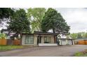 Charming renovated home with mature trees, neutral paint, black trim, and welcoming front porch at 8950 W 26Th, Lakewood, CO 80215