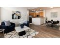Cozy living room featuring modern decor and stylish furniture, seamlessly flowing into the kitchen and dining area at 341 Granby Way # A, Aurora, CO 80011