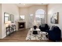 Bright living room with a fireplace, large windows, and modern decor at 341 Granby Way # A, Aurora, CO 80011