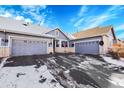 Exterior shot of home featuring a three car garage and beautiful blue sky at 7633 S Addison Way, Aurora, CO 80016
