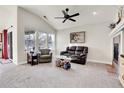 Bright living room with vaulted ceilings, large windows, and cozy fireplace at 7633 S Addison Way, Aurora, CO 80016