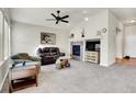 Inviting living room featuring plush seating, a fireplace, and neutral decor at 7633 S Addison Way, Aurora, CO 80016