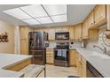 Bright kitchen boasts stainless steel appliances, light wood cabinets, and ample counter space at 13631 E Marina Dr # 502, Aurora, CO 80014