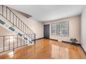 Inviting entryway with hardwood floors and staircase featuring iron railing to the upper level at 8915 Field St # 116, Broomfield, CO 80021