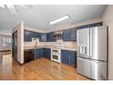 Beautiful open-concept kitchen with stainless steel appliances, modern countertops, and stylish wooden floor at 8915 Field St # 116, Broomfield, CO 80021