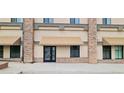 Close up of the building entrance, featuring stone accents, canvas awnings, and a clearly marked suite number at 615 24Th St # 103, Golden, CO 80401