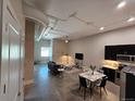 Open-concept living room featuring modern decor, high ceilings, sleek flooring, and a stylish kitchen area at 615 24Th St # 103, Golden, CO 80401