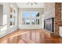 Bright living room with hardwood floors, fireplace, and large windows at 18950 E Geddes Ave, Centennial, CO 80016