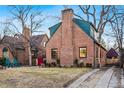 Charming brick home featuring a driveway, a cozy front yard, and a welcoming entrance at 357 Birch St, Denver, CO 80220